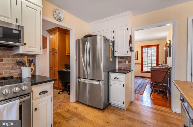 a kitchen with stainless steel appliances a refrigerator stove microwave and sink