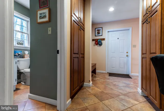 a view of a hallway with closet and wooden floor