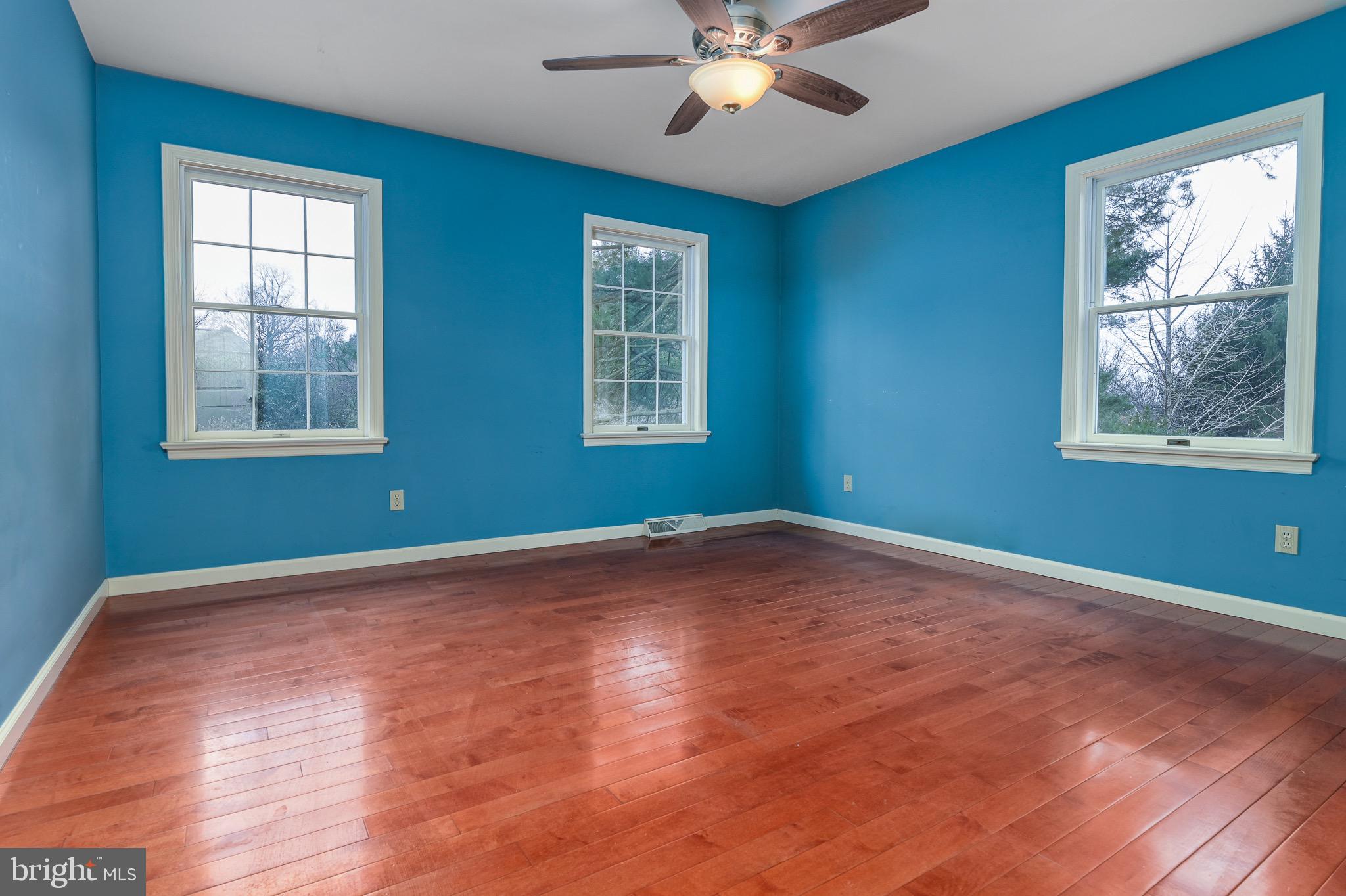12 Phillips Lane Chester Springs, PA 19425 - Photo 35 of 54 a view of an empty room with wooden floor and a window