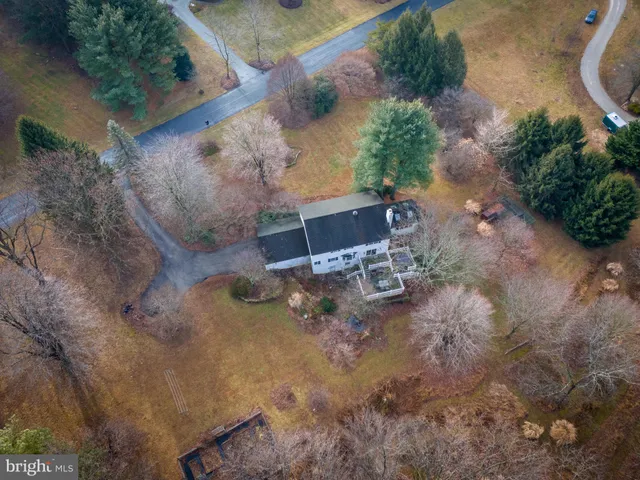 an aerial view of a house with a yard