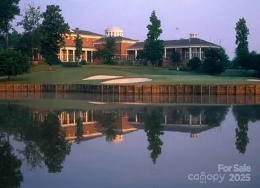 a view of a lake in front of house with a yard