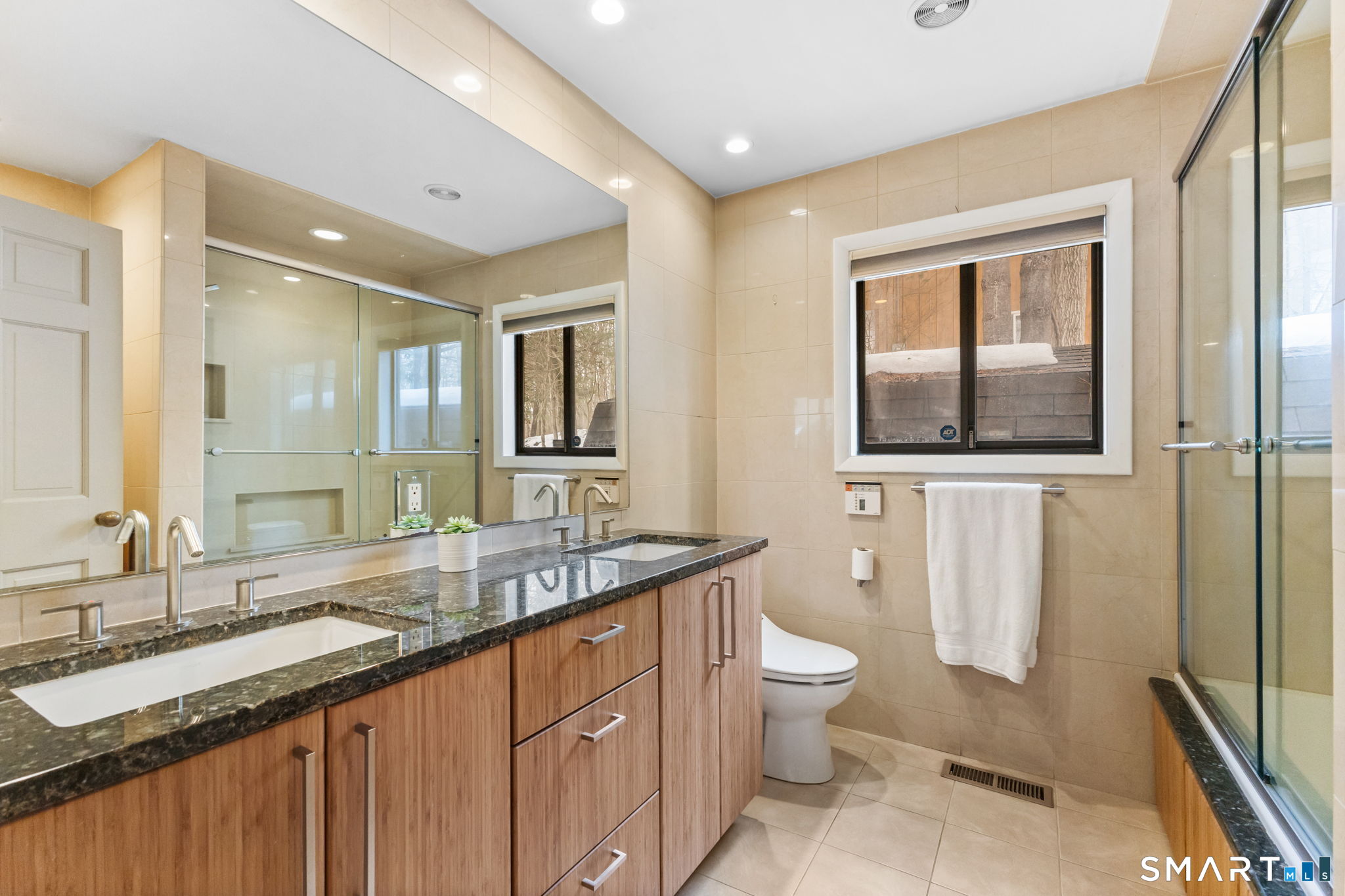 37 Quarry Road Stamford, CT 06903 - Photo 25 of 41 a bathroom with a granite countertop double vanity sink a mirror and a toilet