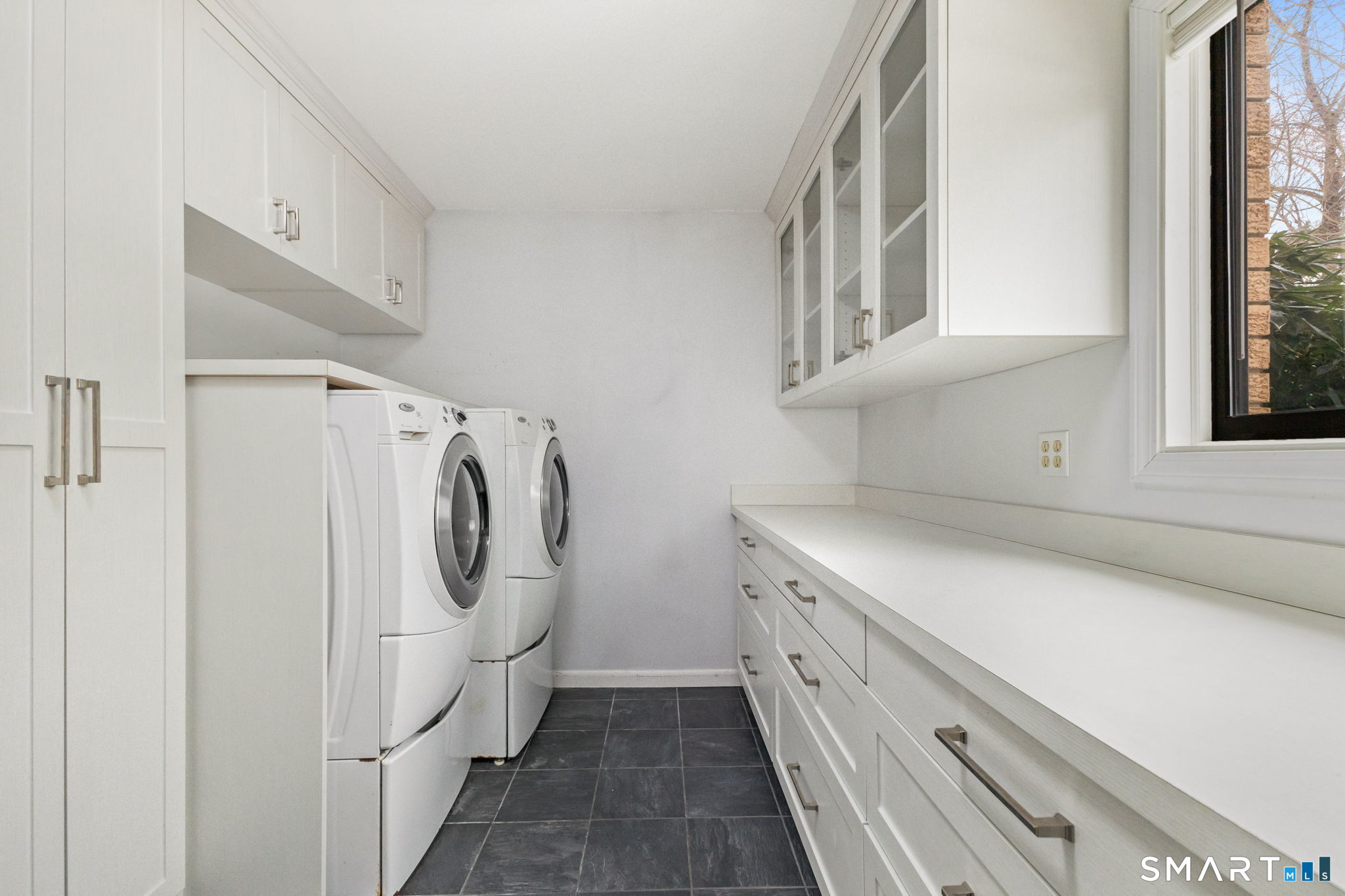 37 Quarry Road Stamford, CT 06903 - Photo 26 of 41 a utility room with cabinets washer and dryer