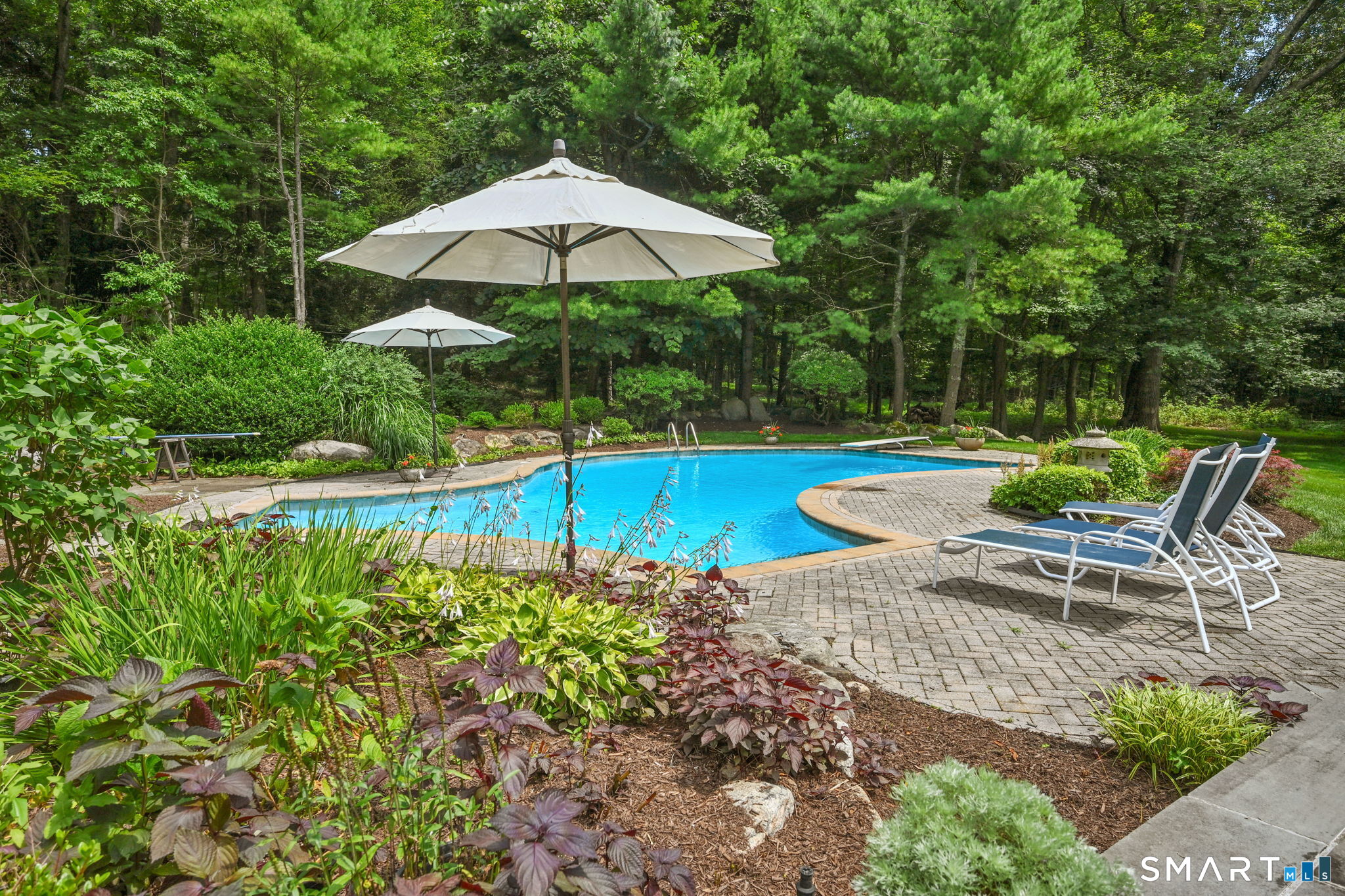 37 Quarry Road Stamford, CT 06903 - Photo 34 of 41 a view of a table and chairs under an umbrella