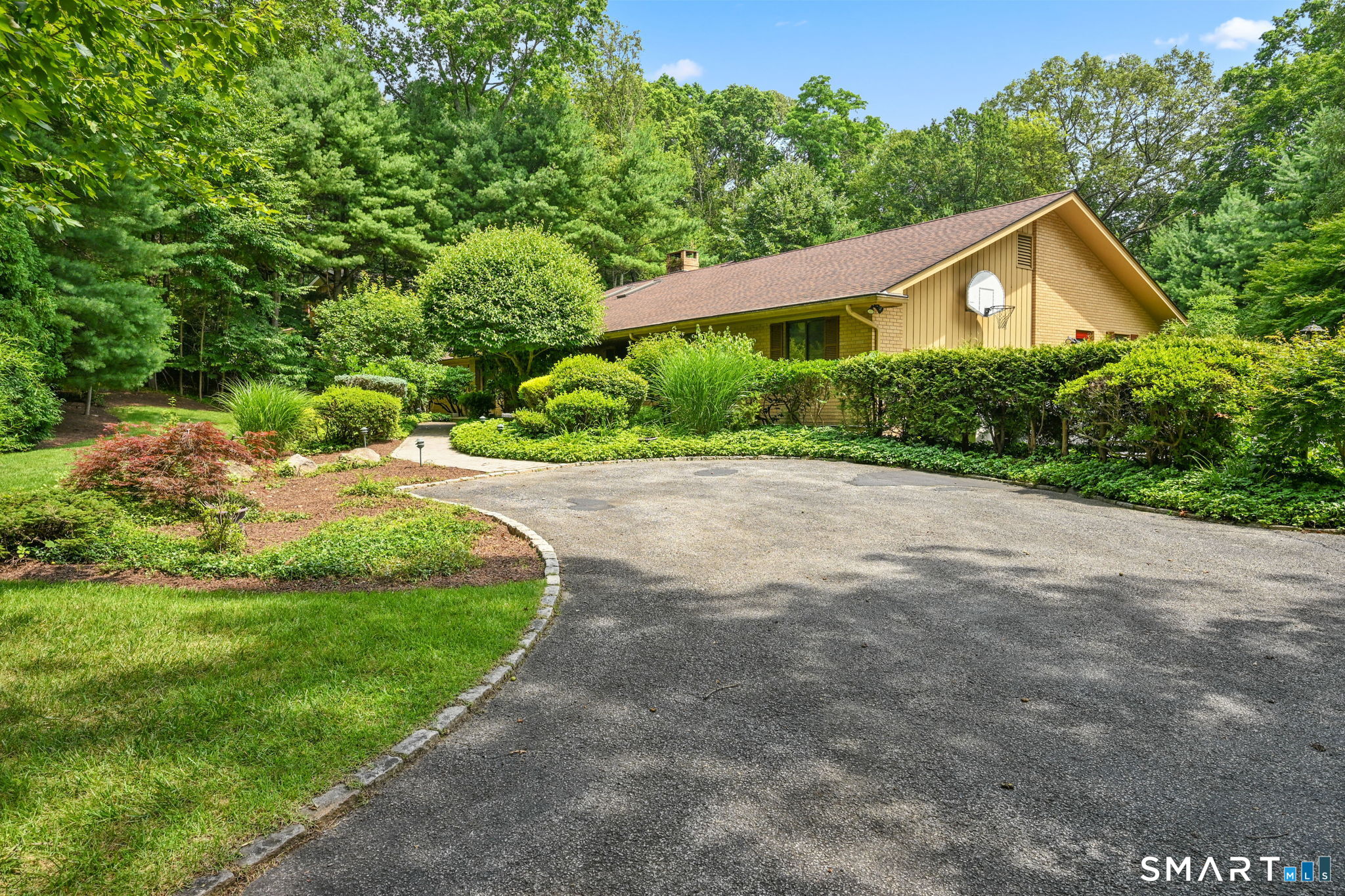 37 Quarry Road Stamford, CT 06903 - Photo 37 of 41 a view of a house with a small yard plants and large trees