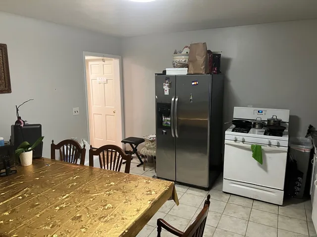 a kitchen with a refrigerator and a stove top oven