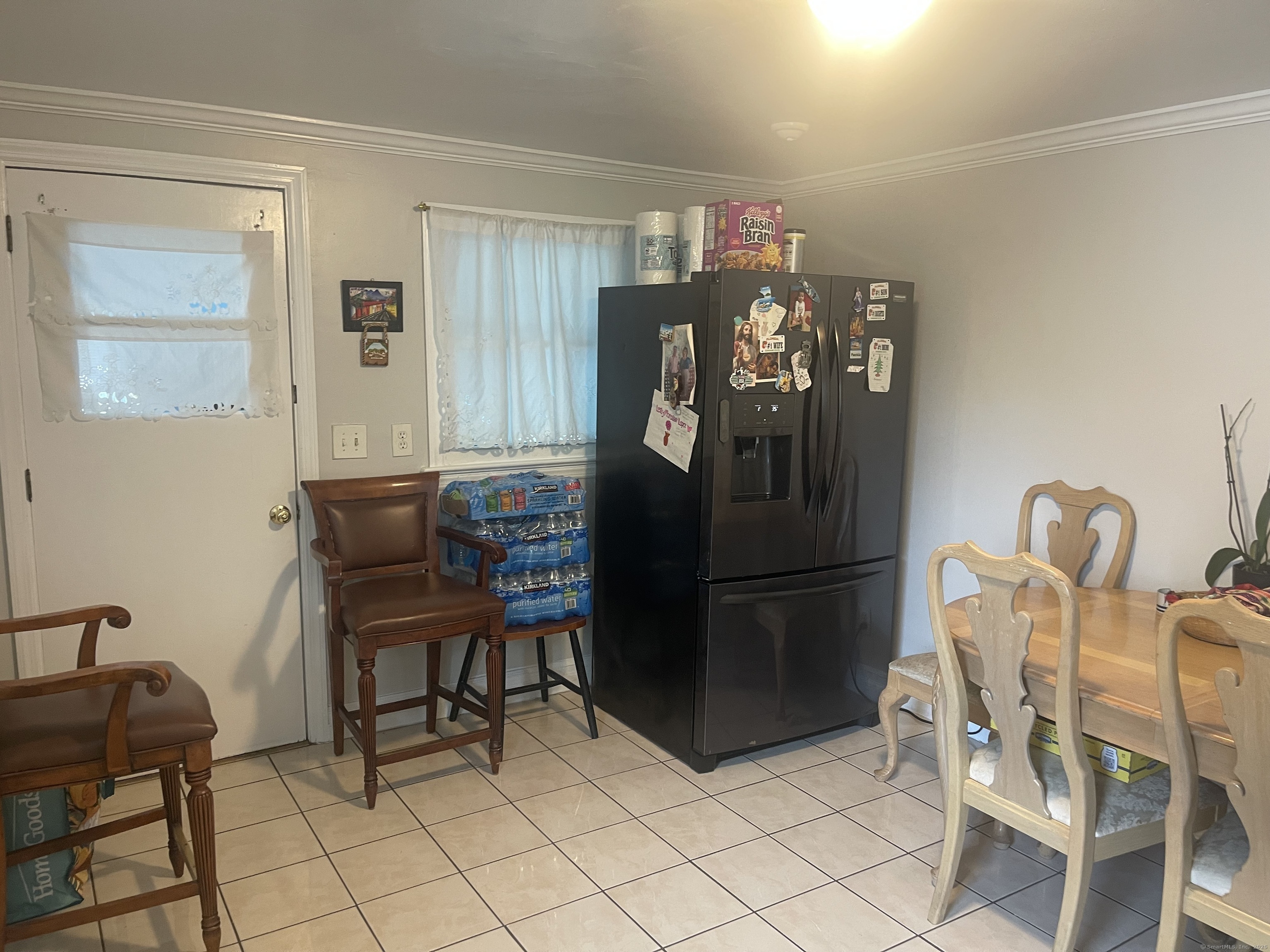 95 Frederick Street Stamford, CT 06902 - Photo 29 of 30 a kitchen with a refrigerator a table and chairs