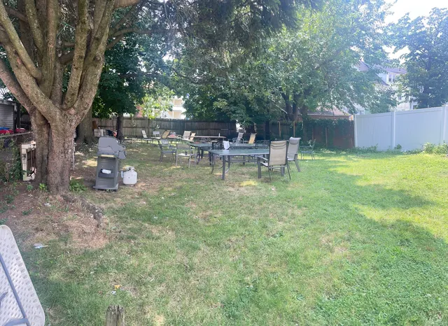 a view of a small yard with a table and chairs