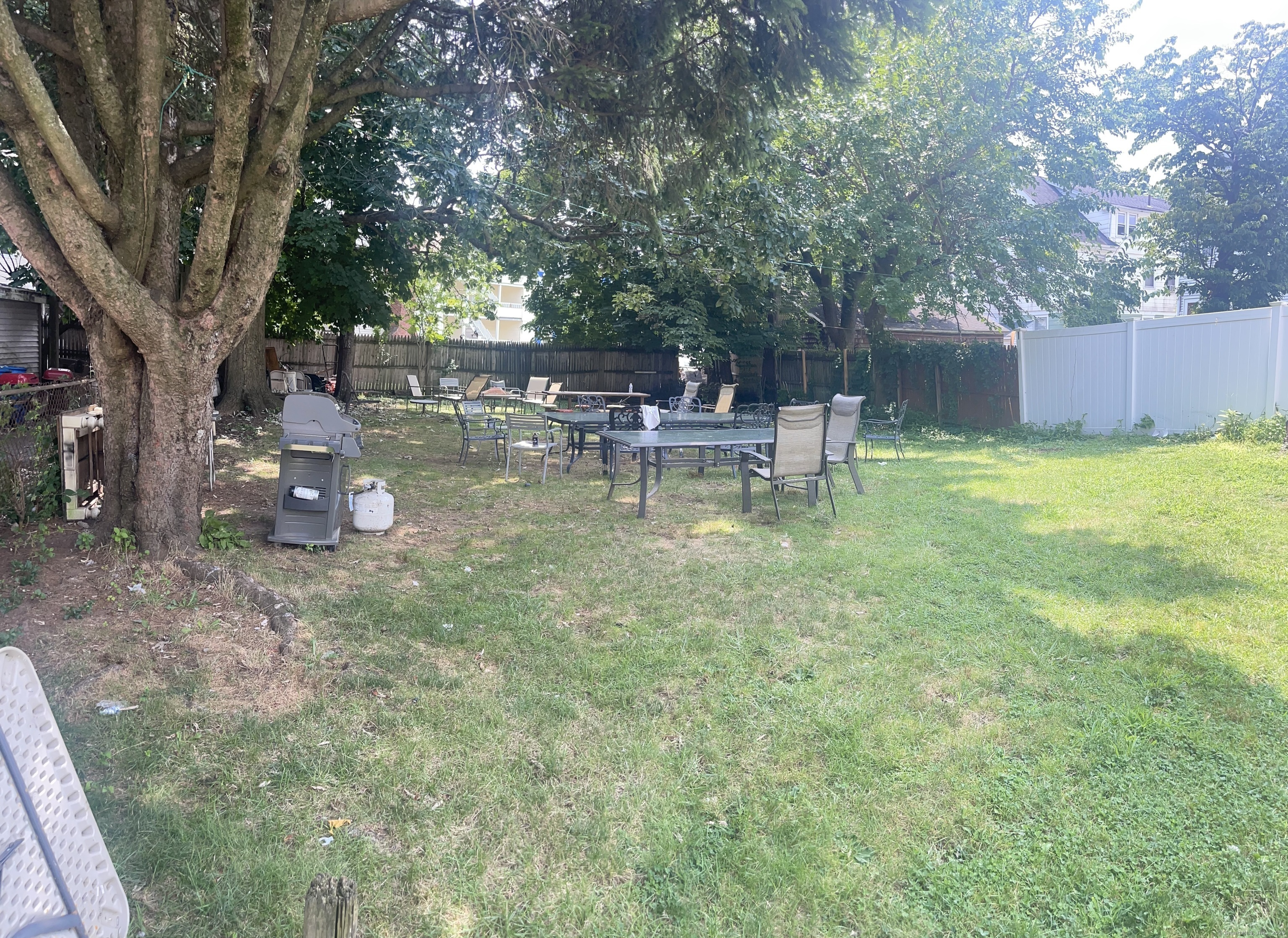 95 Frederick Street Stamford, CT 06902 - Photo 3 of 30 a view of a small yard with a table and chairs