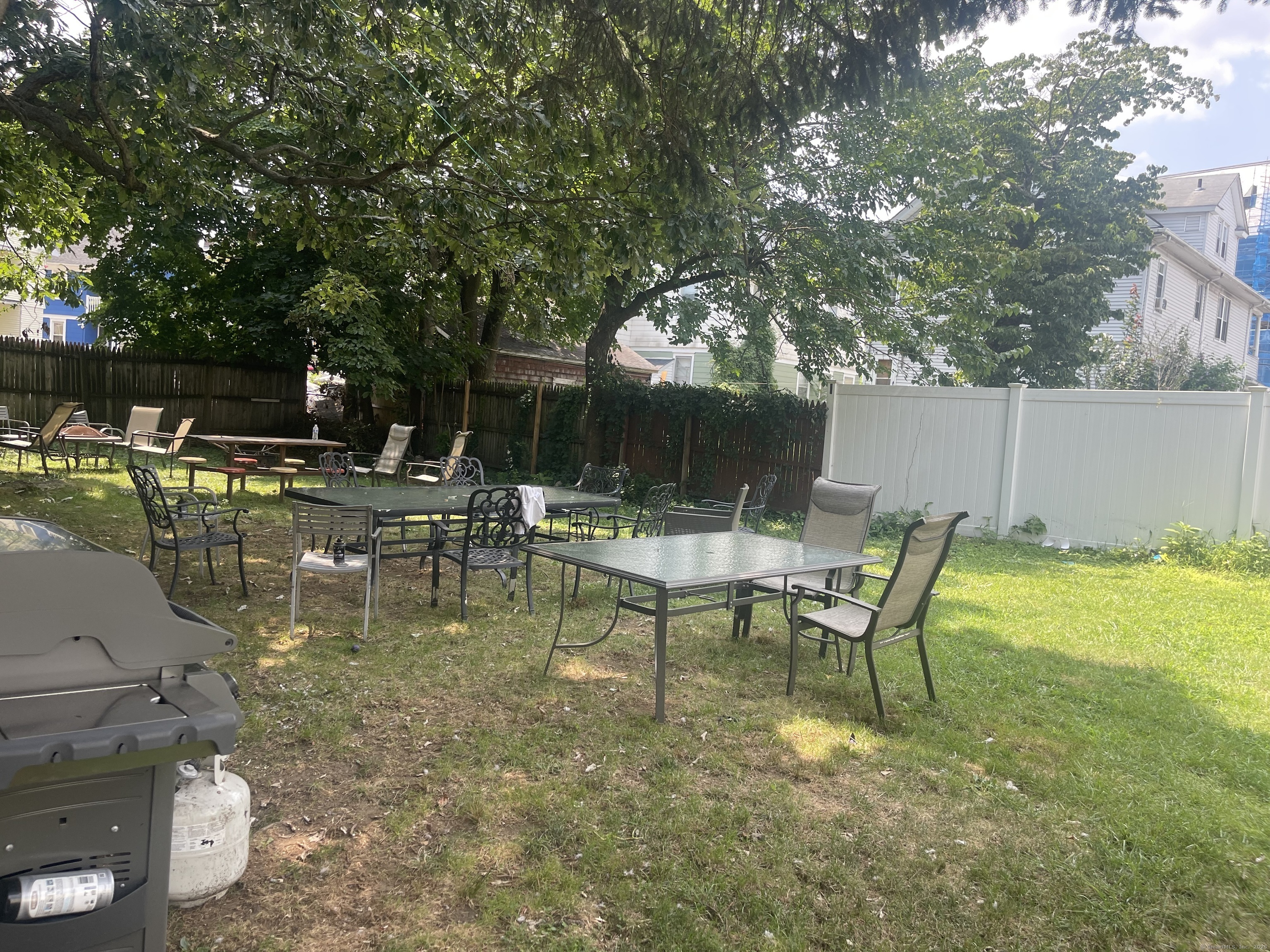 95 Frederick Street Stamford, CT 06902 - Photo 7 of 30 a view of swimming pool with table and chairs potted plants and large tree