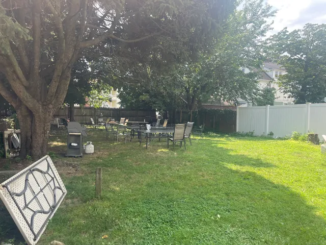 a swimming pool with outdoor seating and yard