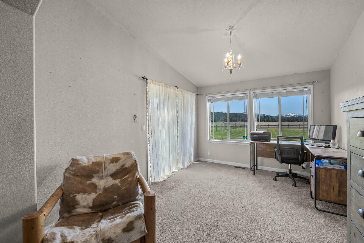 67500 Harrington Loop Road Bend, OR 97703 - Photo 18 of 72 a living room with furniture and a large window