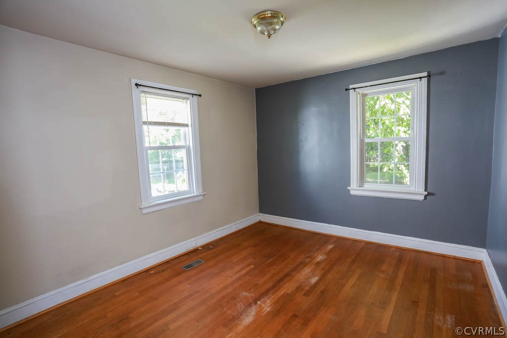 1806 Hilliard Road Henrico, VA 23228 - Photo 13 of 28 a view of an empty room with wooden floor and a window