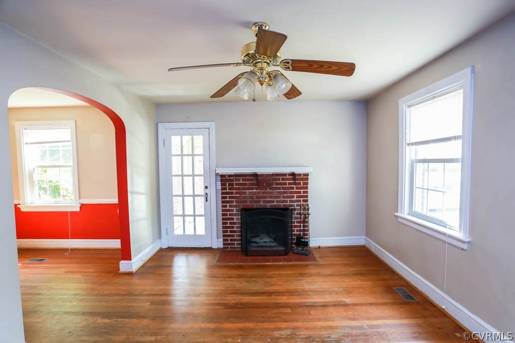 1806 Hilliard Road Henrico, VA 23228 - Photo 2 of 28 an empty room with windows fireplace and wooden floor