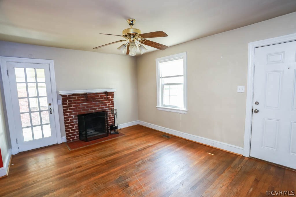 1806 Hilliard Road Henrico, VA 23228 - Photo 4 of 28 an empty room with wooden floor fireplace and windows