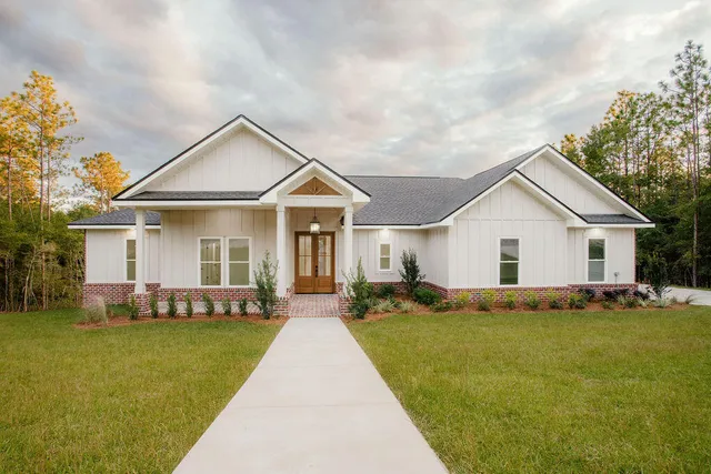a front view of house with yard and green space