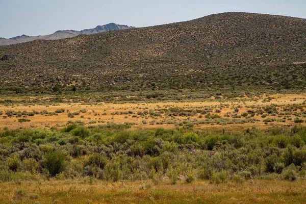 a view of a large mountain with mountains in the background