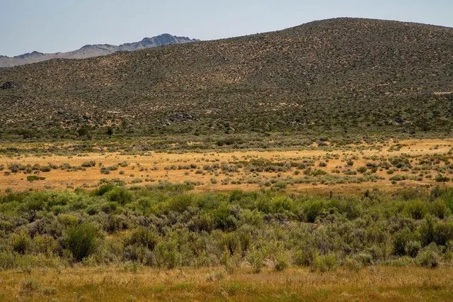 a view of a large mountain with mountains in the background