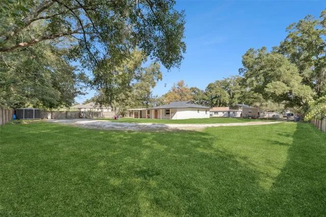 a view of a house with a yard patio and swimming pool