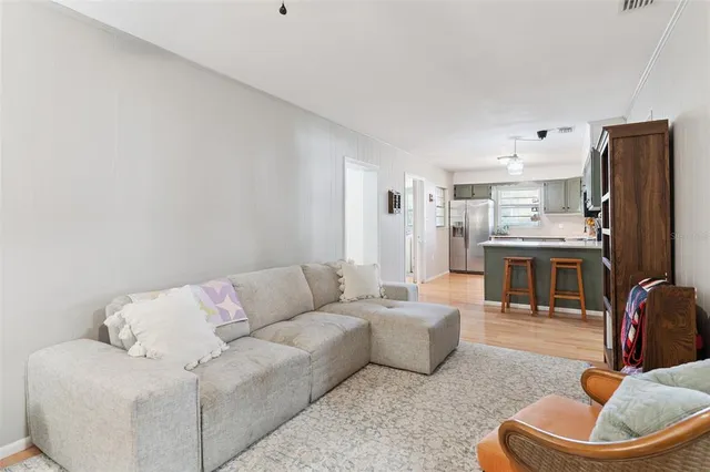 a living room with furniture and a book shelf