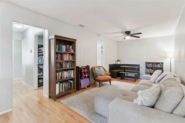 a bedroom with a bed a dresser with wooden floor