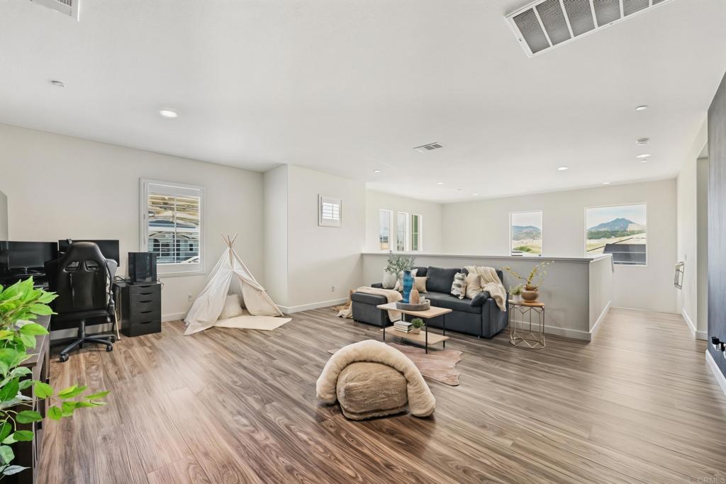 4634 Silent Knoll Drive Fallbrook, CA 92028 - Photo 17 of 26 a living room with furniture a table and wooden floor