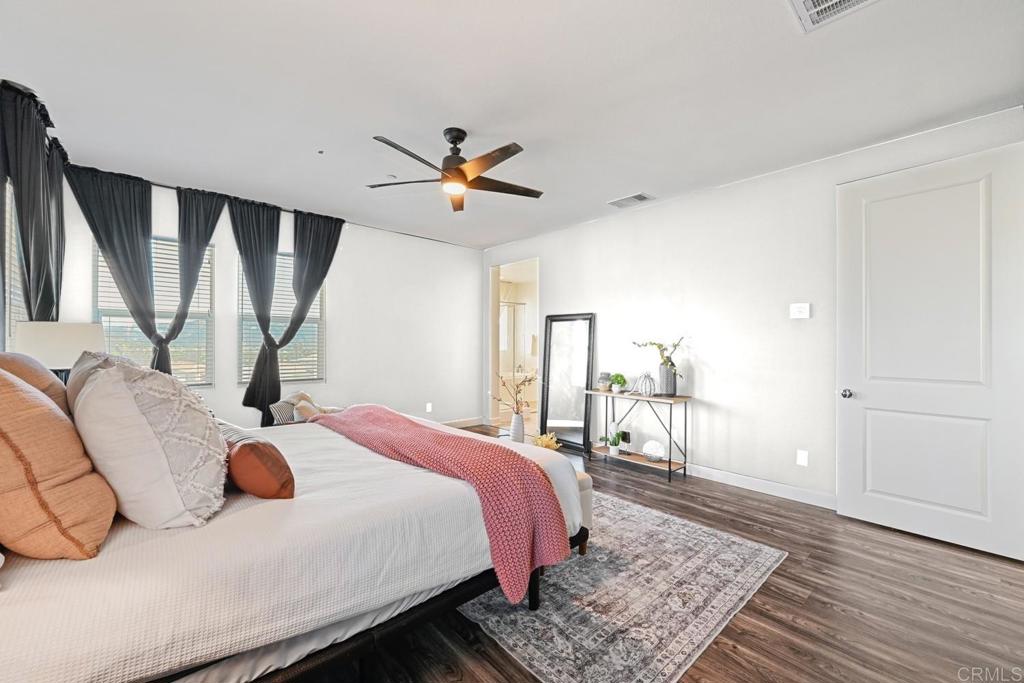 4634 Silent Knoll Drive Fallbrook, CA 92028 - Photo 18 of 26 a bedroom with a bed a rug and wooden floor