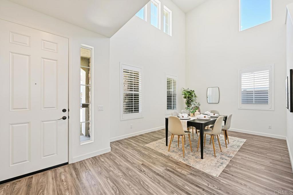 4634 Silent Knoll Drive Fallbrook, CA 92028 - Photo 6 of 26 a dining room with wooden floor and white walls