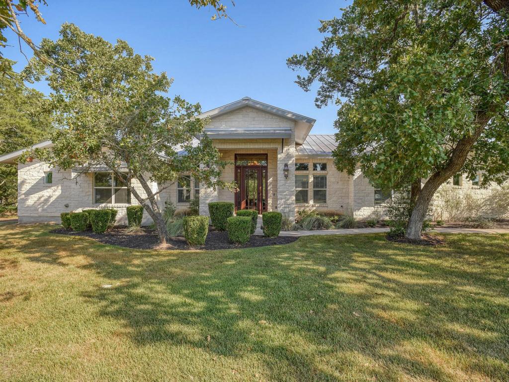a view of a house with a tree in a yard