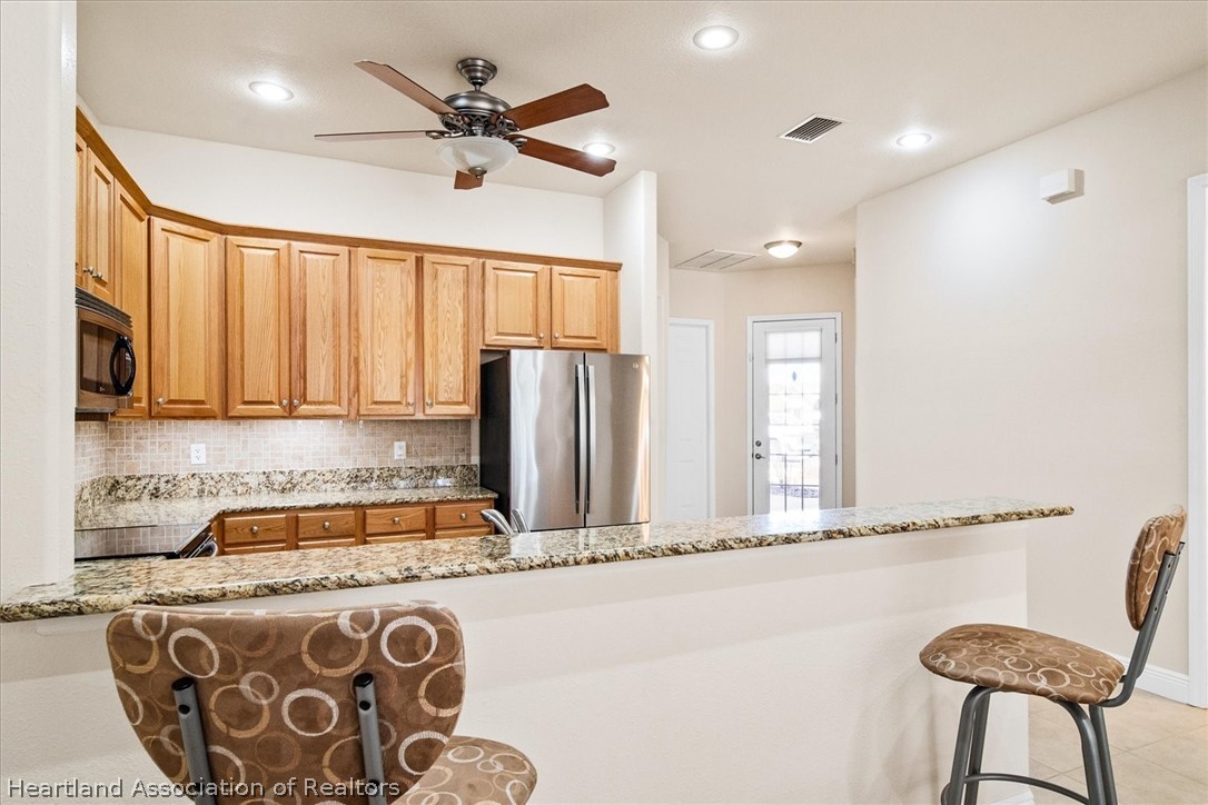 5224 Haw Branch Road Sebring, FL 33875 - Photo 6 of 40 a kitchen with a refrigerator and a sink