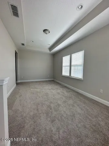 an empty room with a empty space and windows