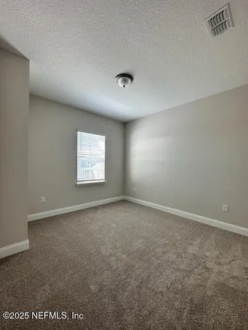 a view of an empty room with windows