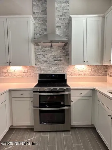 a kitchen with granite countertop a stove and a sink