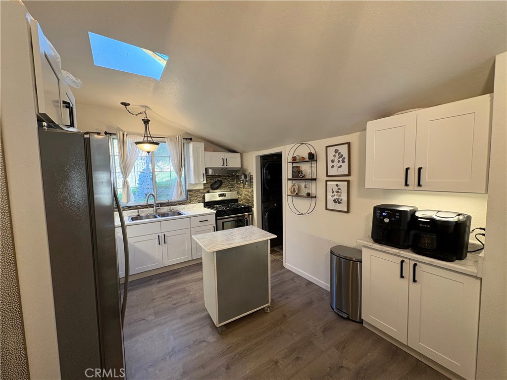 36750 Hilltop Road Yucaipa, CA 92399 - Photo 10 of 27 a kitchen with stainless steel appliances a refrigerator stove and white cabinets