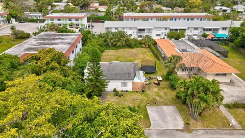 an aerial view of a house with a garden and lake view
