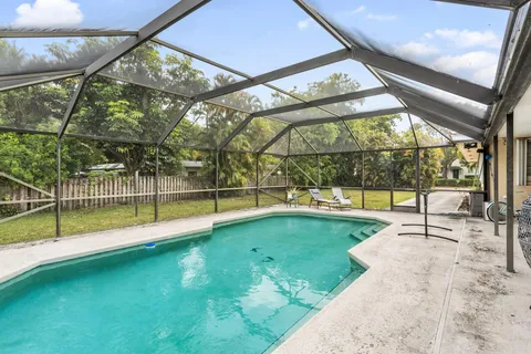 a view of a house with yard and sitting area