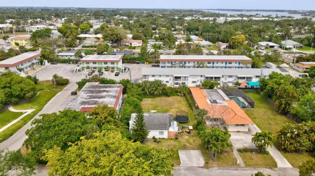 an aerial view of residential houses with outdoor space and parking