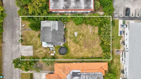 an aerial view of a house with a yard basket ball court and outdoor seating