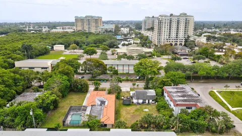 an aerial view of a house with garden space and street view