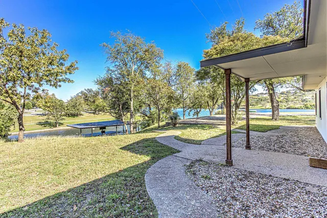 a view of a chairs and table in the backyard