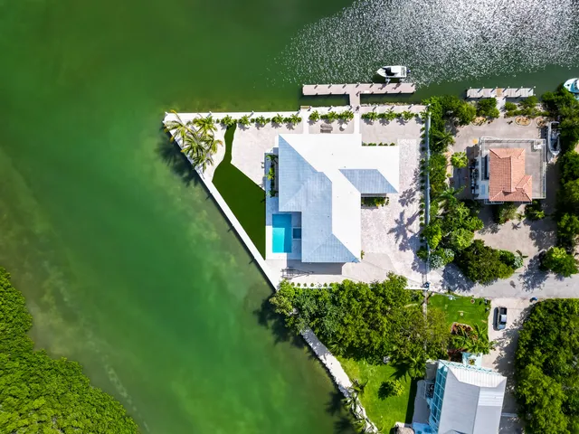 an aerial view of a house with a yard basket ball court and outdoor seating