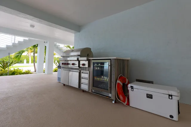 a bedroom with a large bed and a flat tv screen on dresser