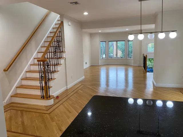 a view of entryway and hall with wooden floor