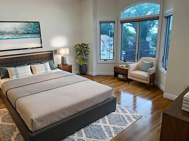 a bedroom with a large bed and a large window