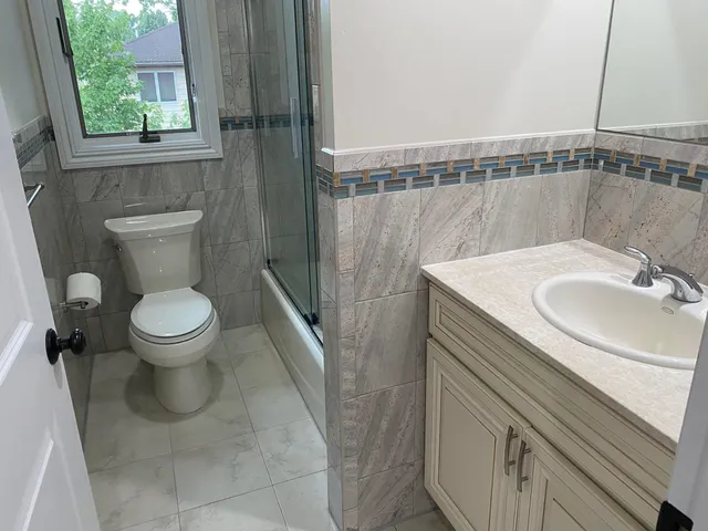 a bathroom with a sink a toilet and a mirror