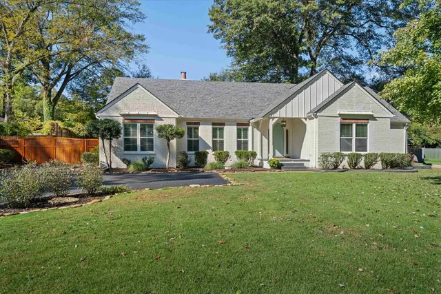 a view of a house with backyard sitting area and garden