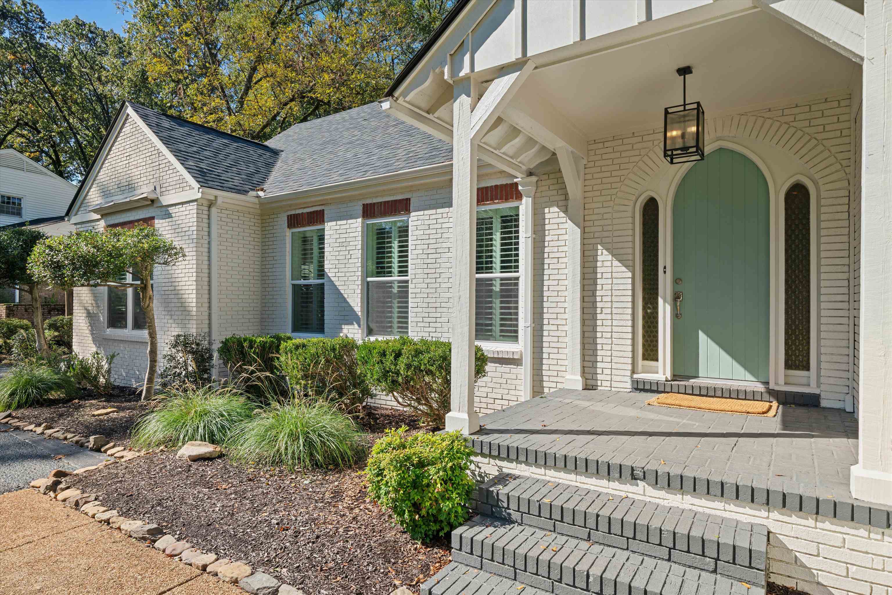 159 Perkins Extension Memphis, TN 38117 - Photo 2 of 37 a front view of a house with a garden