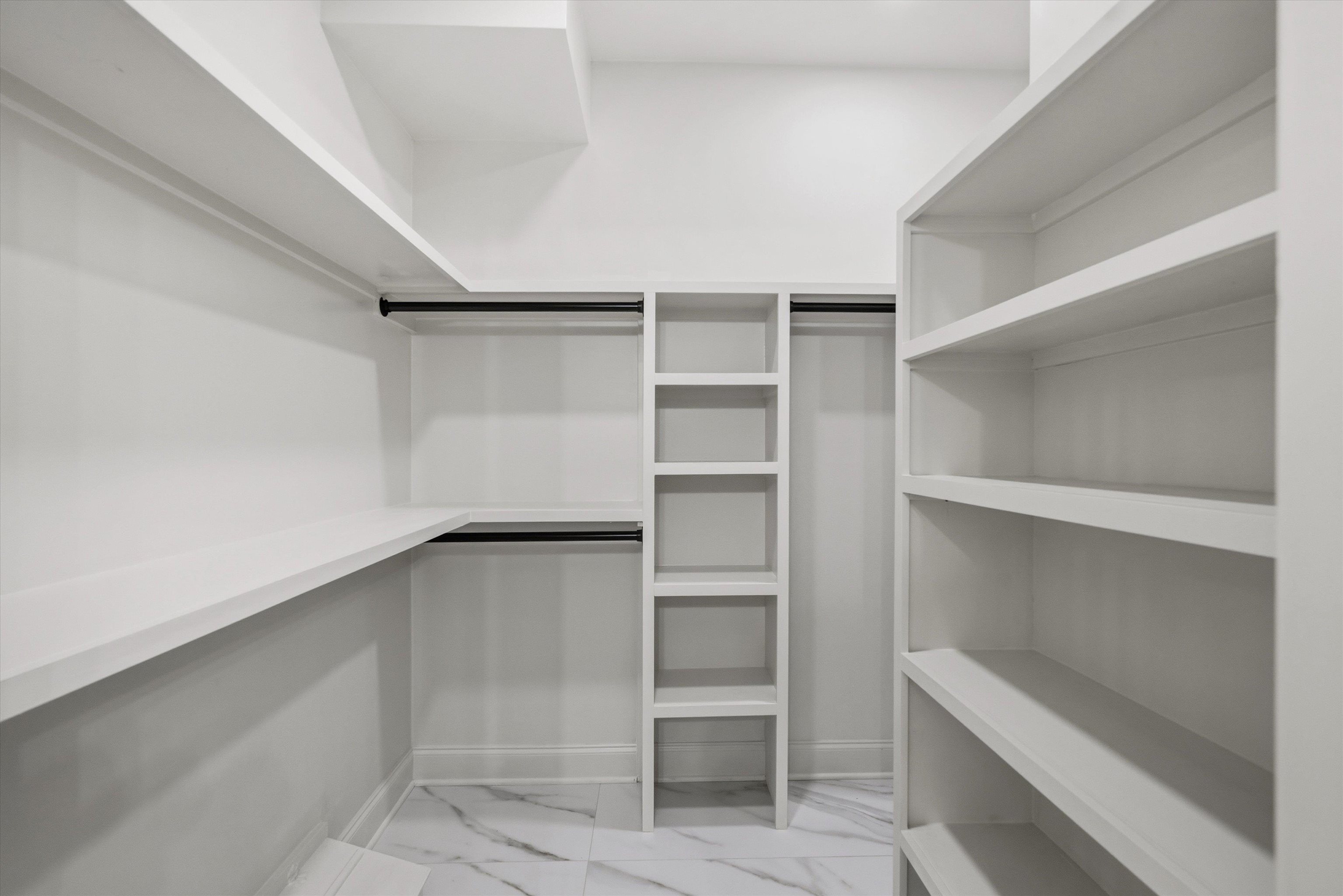 159 Perkins Extension Memphis, TN 38117 - Photo 22 of 37 a walk in closet with empty racks