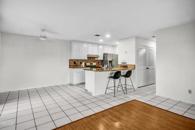 a kitchen with stainless steel appliances a refrigerator and a stove top oven