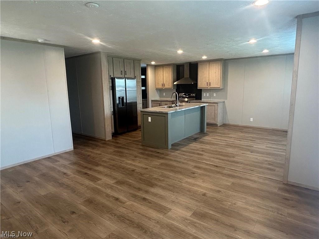 252 Front Street Philo, OH 43771 - Photo 2 of 17 Kitchen with stainless steel appliances, a center island with sink, recessed lighting, and dark wood-type flooring